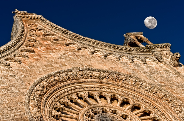 Moon and the stone Ostuni cathedral at sunset